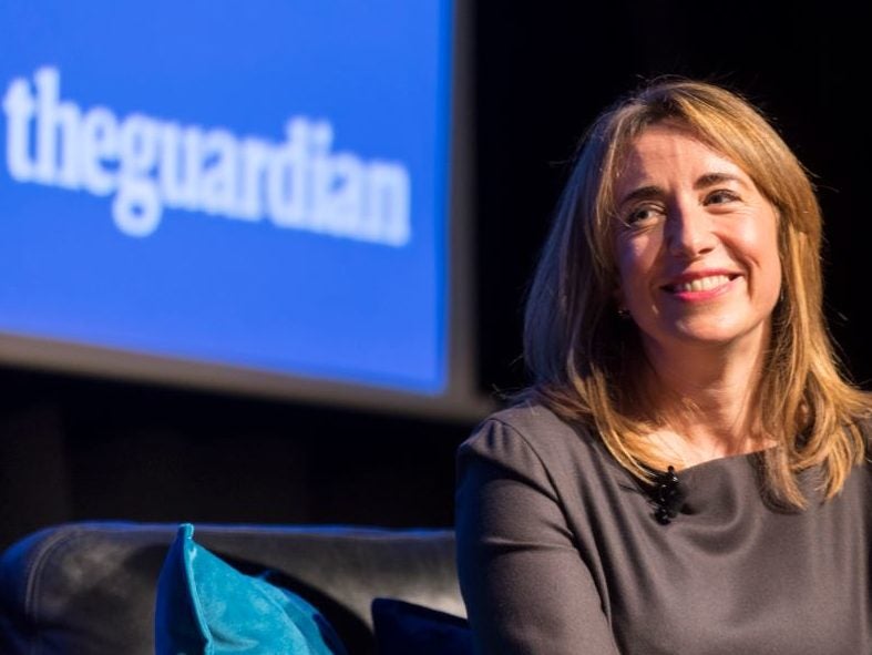 Guardian editor-in-chief Kath Viner on stage in front of a 'The Guardian' logo backdrop