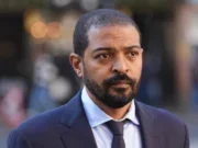 Noel Clarke arrives at the Royal Courts of Justice in London for Guardian libel trial closing arguments. Clarke is wearing a suit and looking past the camera as he walks